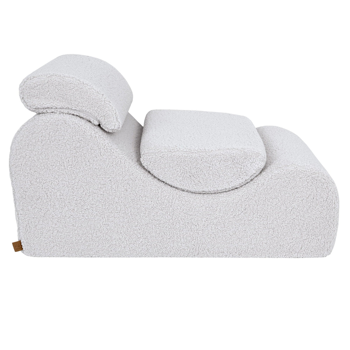 6. Side view of White Wave Lounger with headrest and seat cushion, showcasing its contoured design in a studio setting