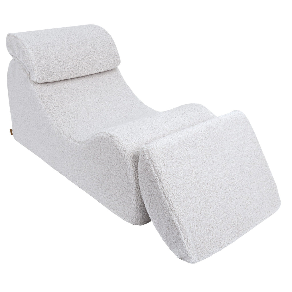 4. White Wave Lounger with fully extended footrest, emphasizing comfort and adjustability in a studio setting