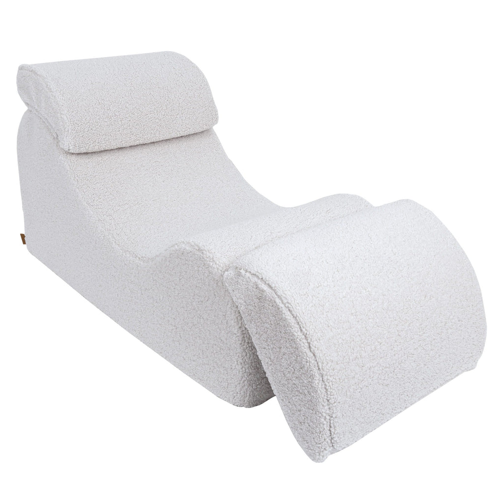 3. White Wave Lounger with footrest partially extended, showcasing its versatility in a studio setting