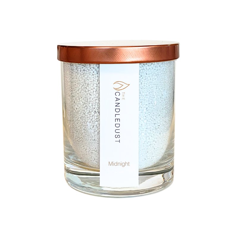 4. Studio shot of Candledust Midnight powdered candle in transparent glass with rose gold lid