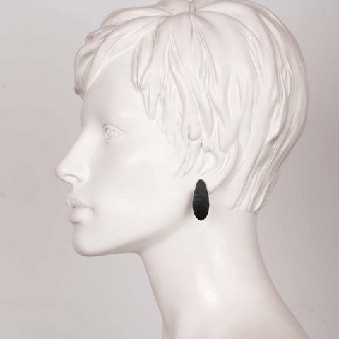 1. Side profile of mannequin wearing Tanel Veenre Mini Blackcurrants Earring with black velvety finish