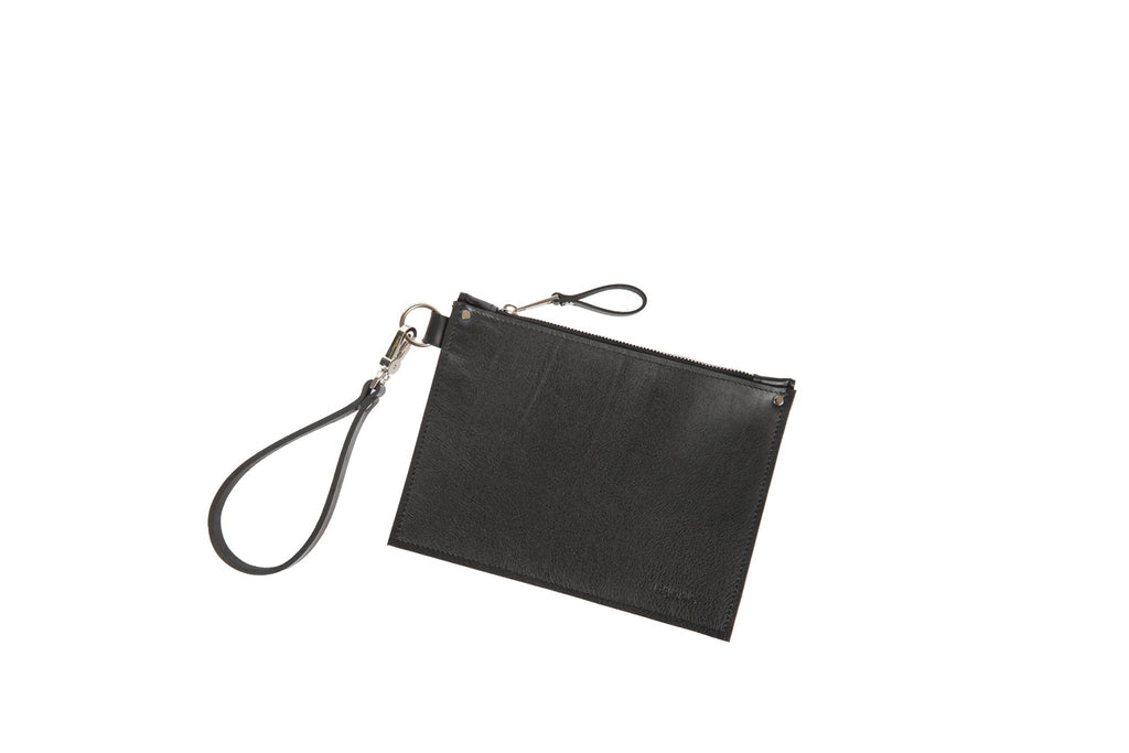 4. Studio shot of black leather Clutch Nina by PYKOK with wrist strap, shown flat on white background