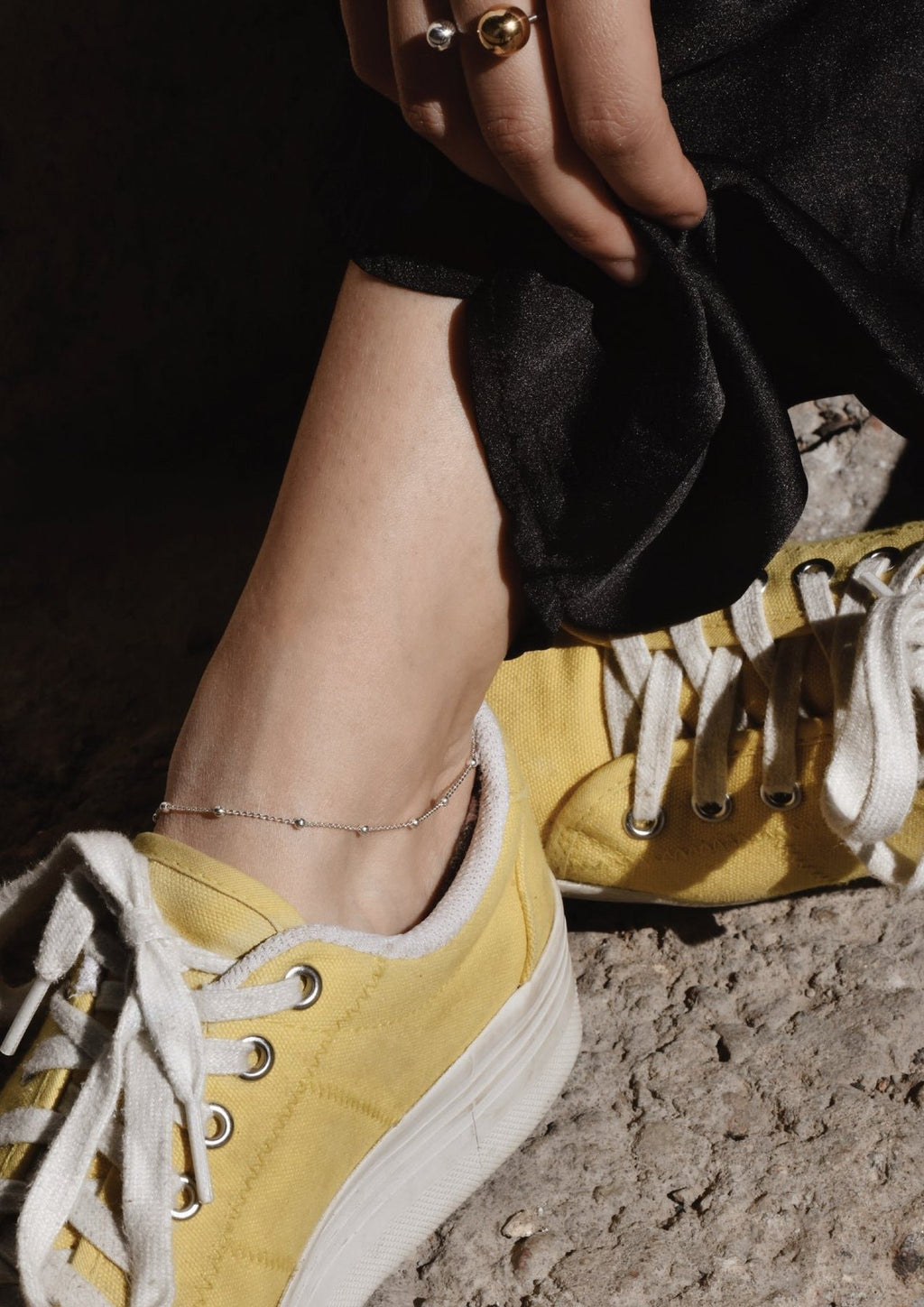 2. Women's Mini Bubble Anklet in sterling silver paired with yellow sneakers, highlighting elegant simplicity