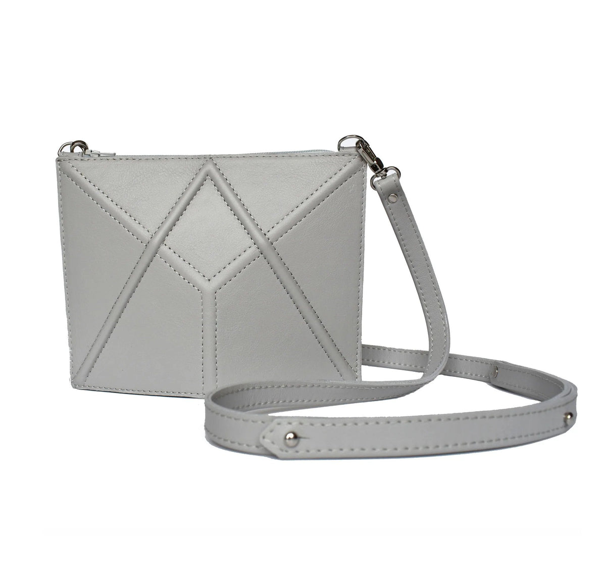 6. Studio shot of light grey FACET Mini leather bag by Gerda Retter Design with adjustable strap