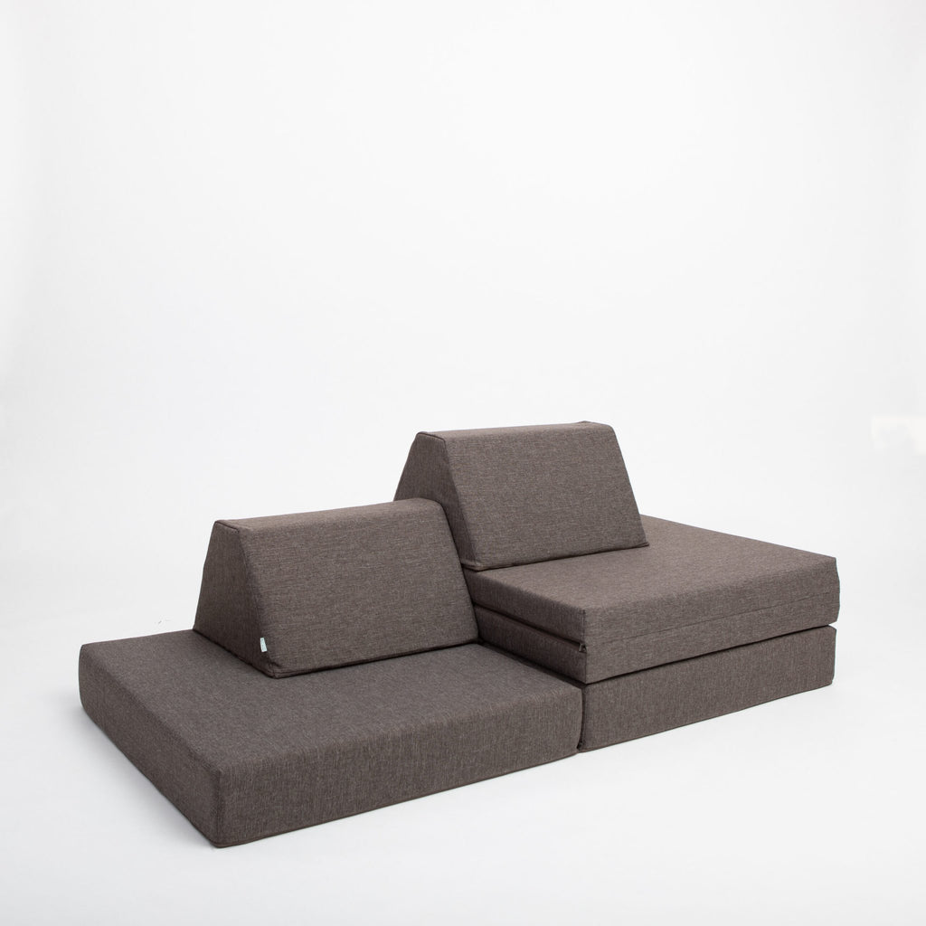 13. Monboxy dark brown play mattress set configured as a lounge chair in a studio