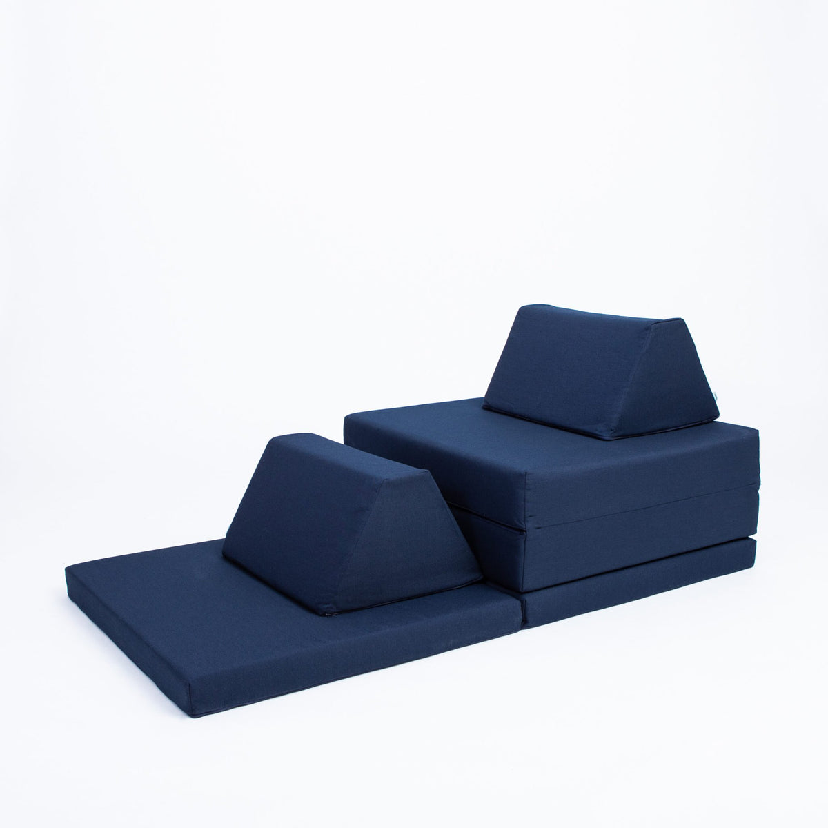 2. Navy blue play mattress set stacked with trapezoidal pillows on a white background