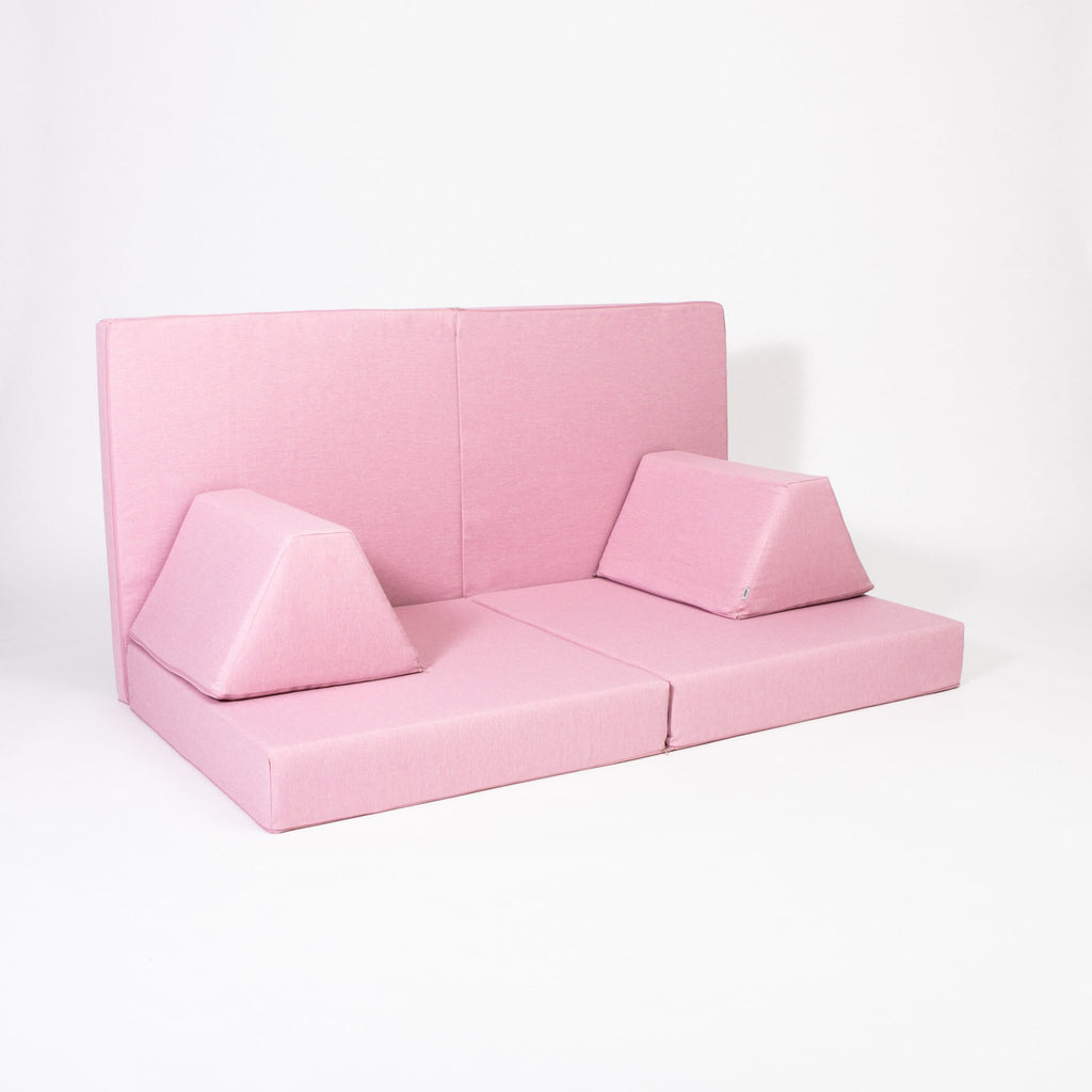 2. Pink play mattress set with trapezoidal pillows arranged as a sofa on a white background