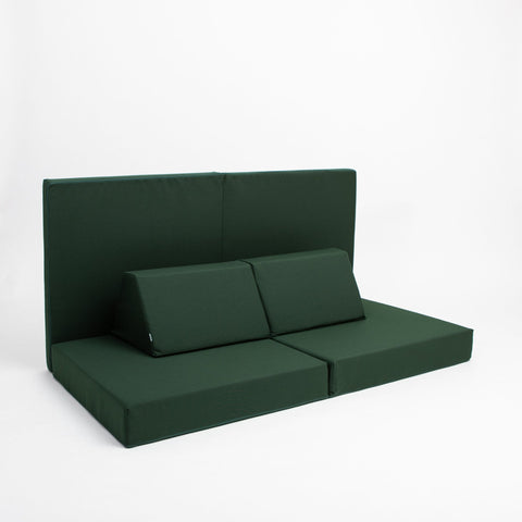 2. Monboxy deep green play mattress set with backrest in a studio setting