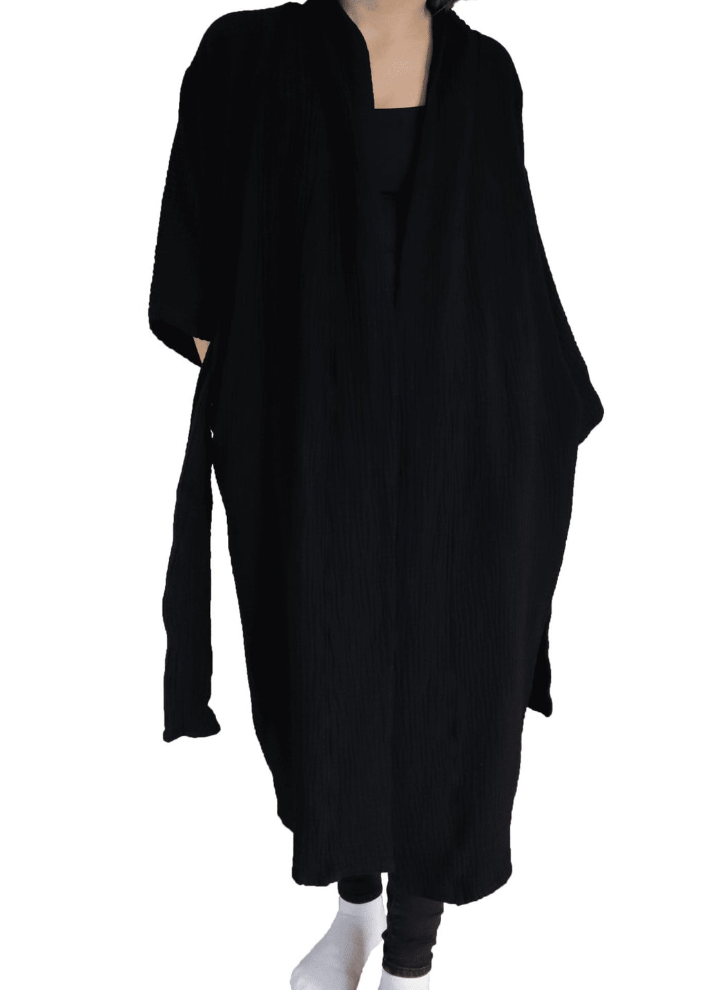 5. Close-up of folded black ÜRP robe with brand logo, highlighting fluffy texture