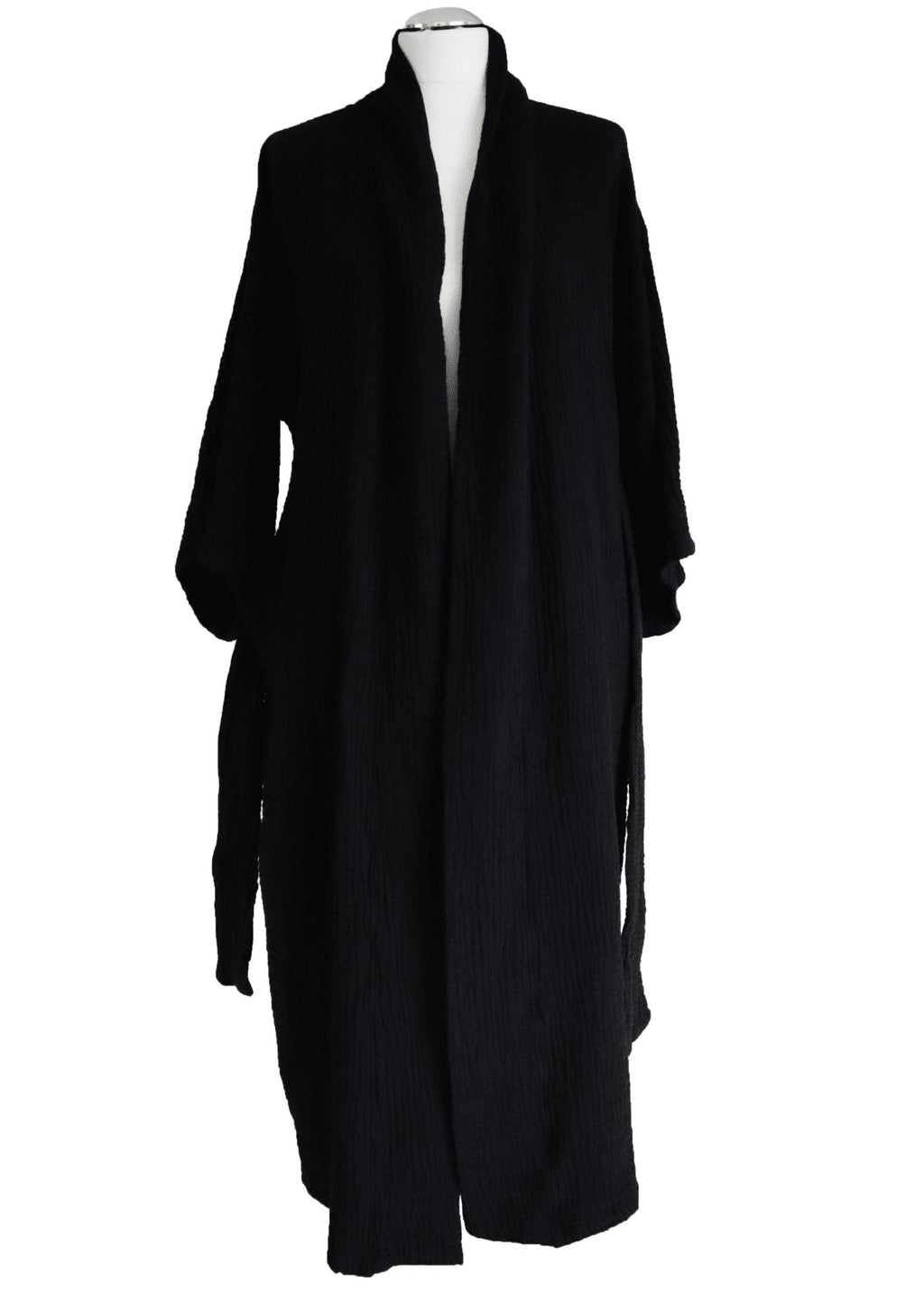 7. Side view of black ÜRP robe in studio, showcasing minimalist design