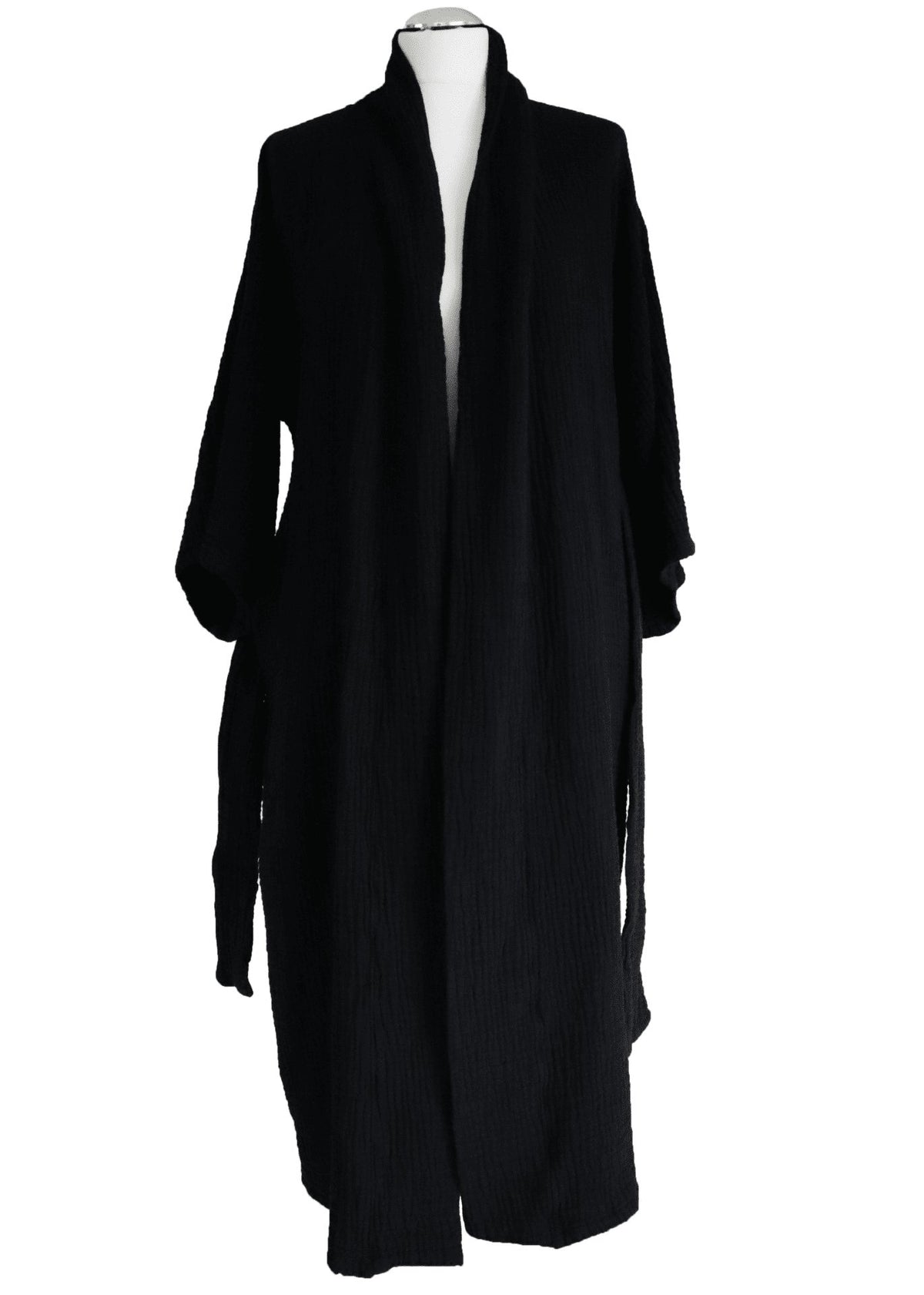 7. Side view of black ÜRP robe in studio, showcasing minimalist design