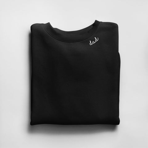 4. Black unisex organic cotton sweatshirt with 'dad' embroidery, folded in studio setting