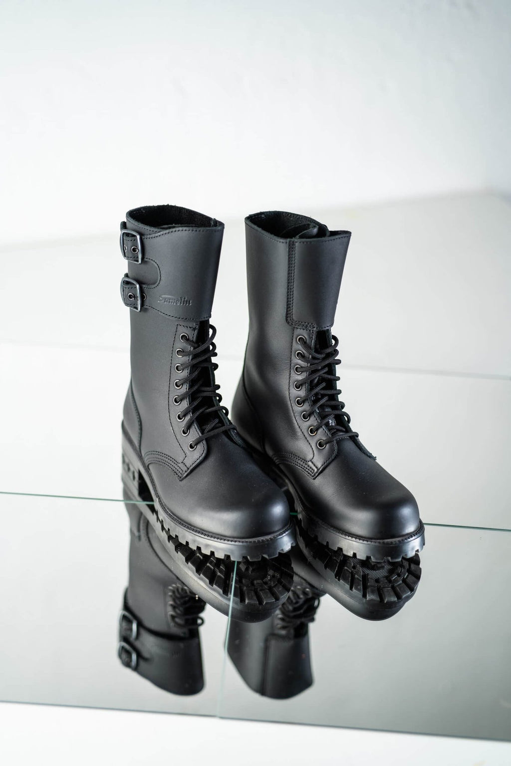 6. Pair of unisex black Tarkovsky boots by Samelin in studio, showcasing front and side design