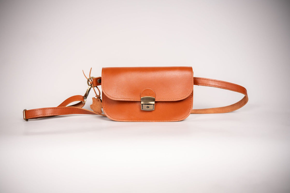 6. Studio shot of Zelma Kraft natural leather saddle bag mini in light brown, highlighting compact design