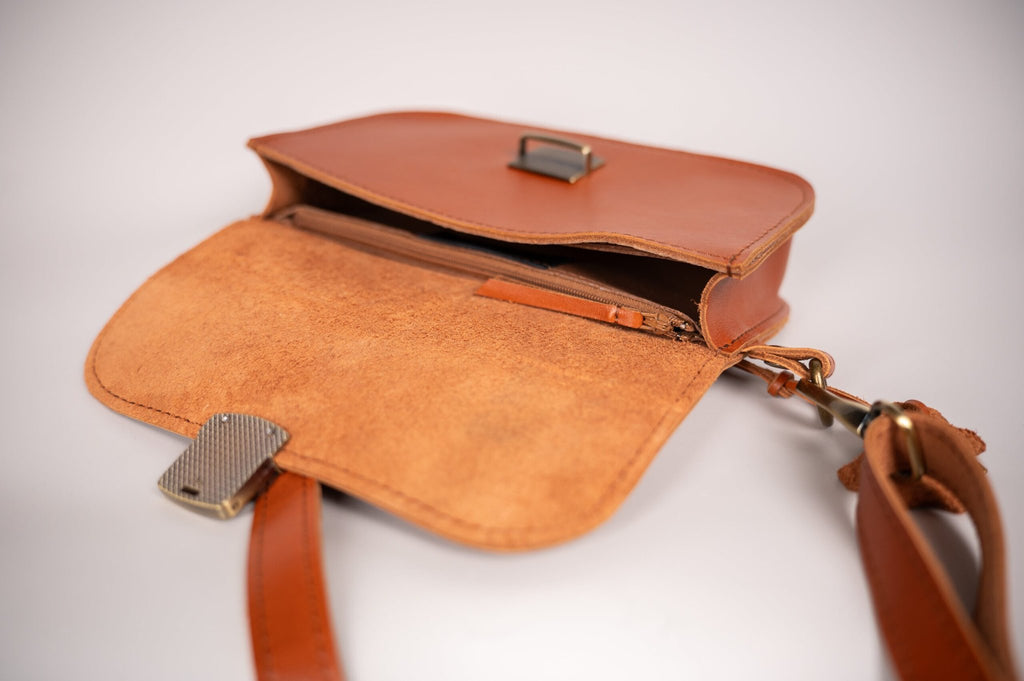 4. Close-up of Zelma Kraft saddle bag interior, showing natural pigskin leather lining and secure zipper pocket