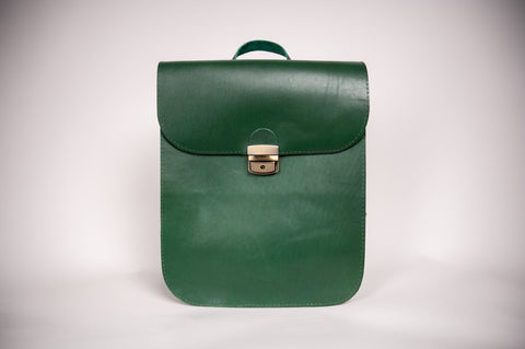 3. Studio shot of Zelma Kraft green leather saddle backpack, showcasing minimalist design and semi-glossy finish