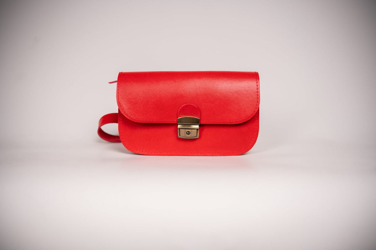 5. Studio shot of Zelma Kraft red leather saddle bag, showing front view and buckle detail