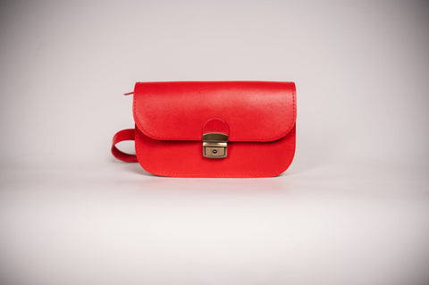 5. Studio shot of Zelma Kraft red leather saddle bag, showing front view and buckle detail