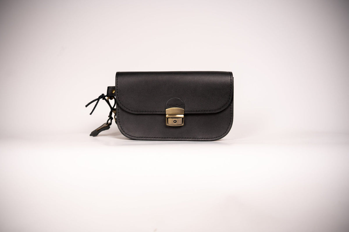 5. Studio shot of black Zelma Kraft natural leather saddle bag mini with buckle closure
