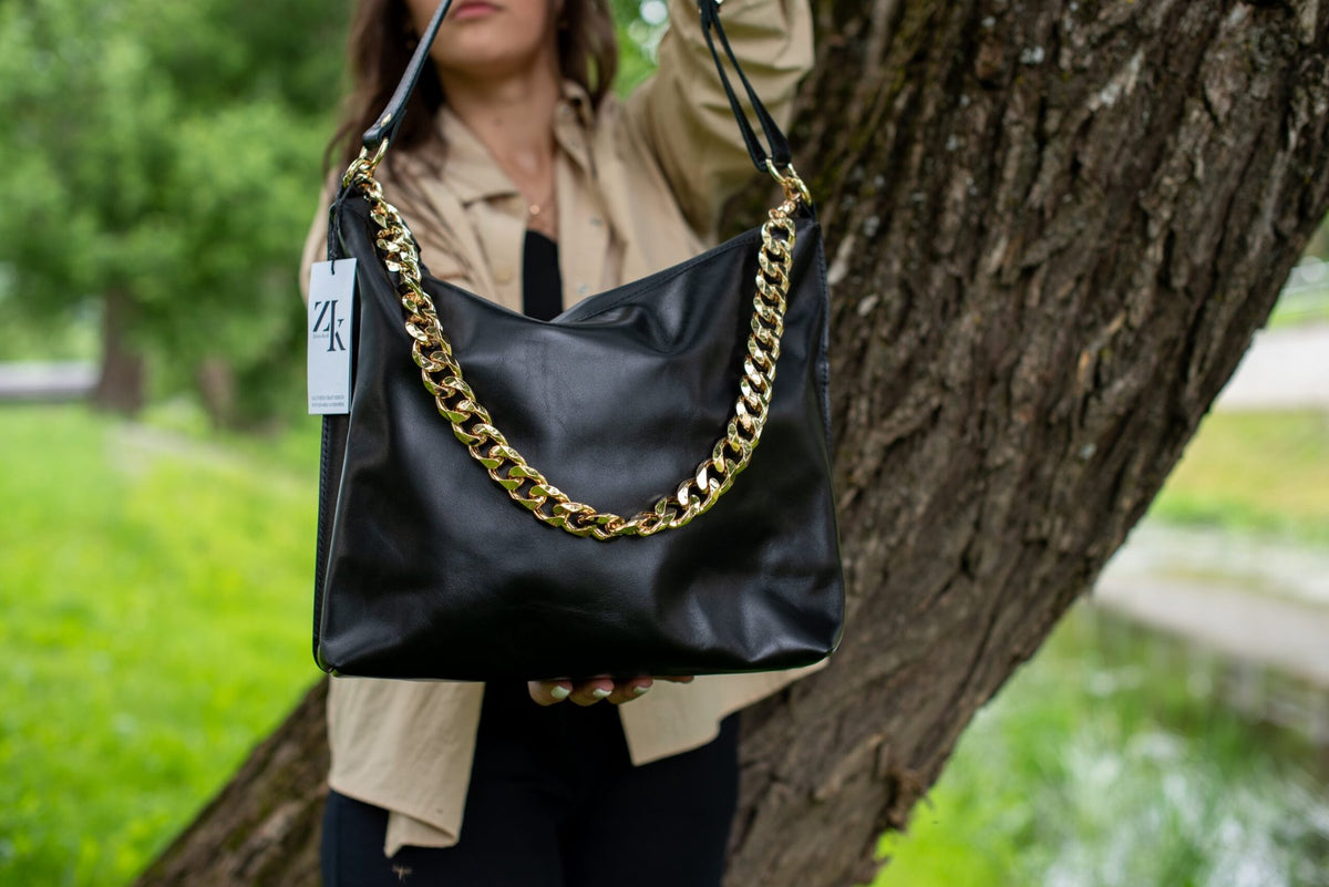 5. Studio shot of Zelma Kraft black leather hobo bag with gold chain and leather strap