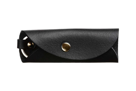5. Black leather key holder by Stella Soomlais closed with snap button, shown from side on white background