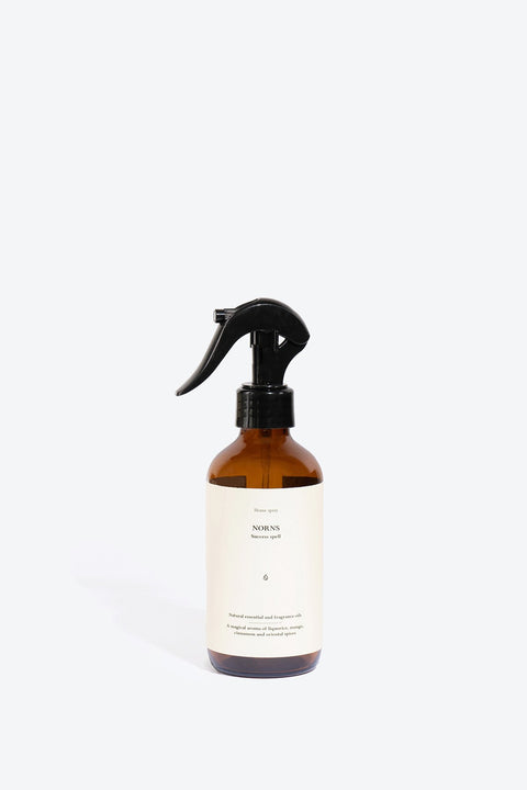 2. Studio image of Perfumed Home Spray NORNS by Smells Like Spells in amber bottle with minimalist label