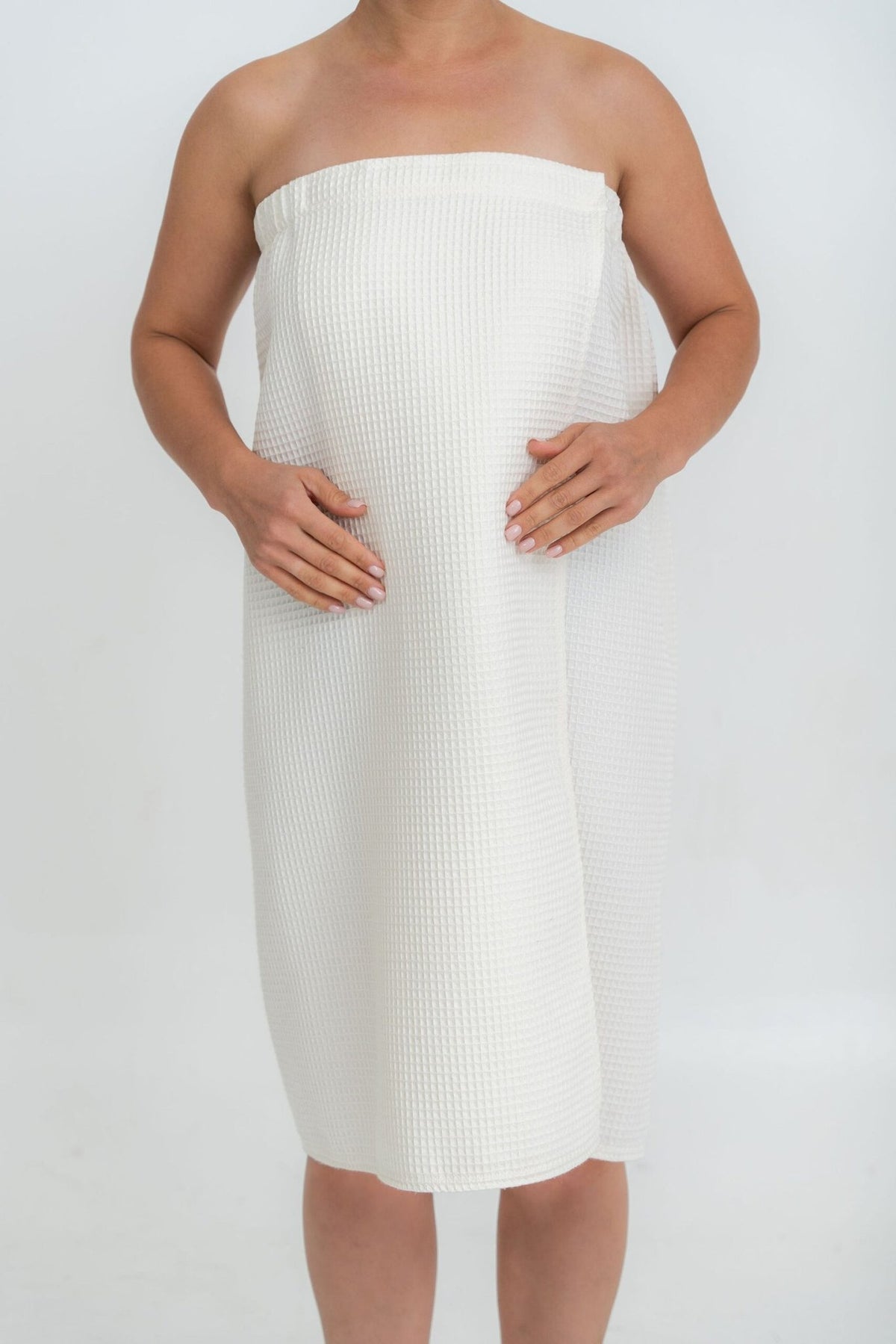 2. Woman wearing cream spa wrap towel with Velcro fastening, shown from front, on white background