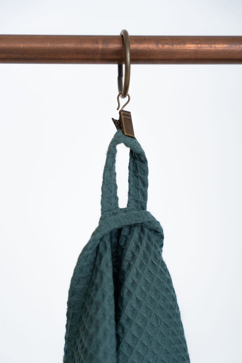 4. Detail of hanging loop on petrol organic waffle cotton towel on copper rack