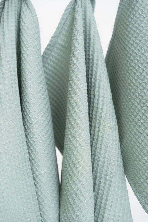 3. Close-up of sage green waffle cotton towels showing texture and weave pattern