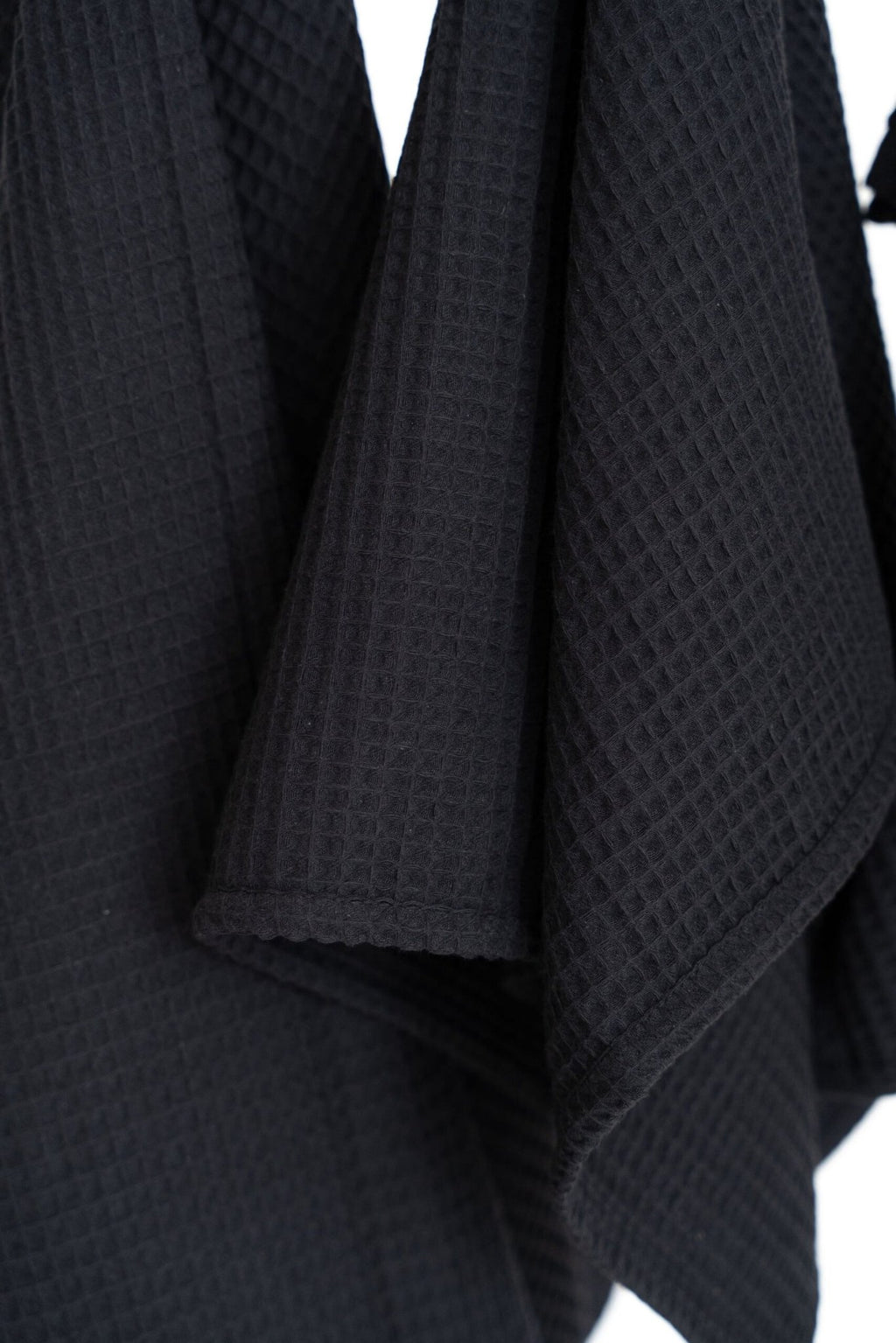 5. Close-up of black waffle cotton towel texture, highlighting the weave and material quality