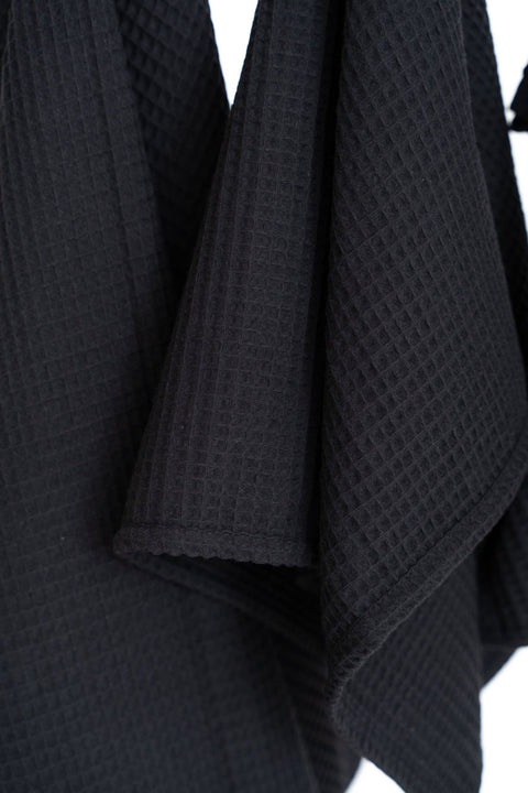 5. Close-up of black waffle cotton towel texture, highlighting the weave and material quality