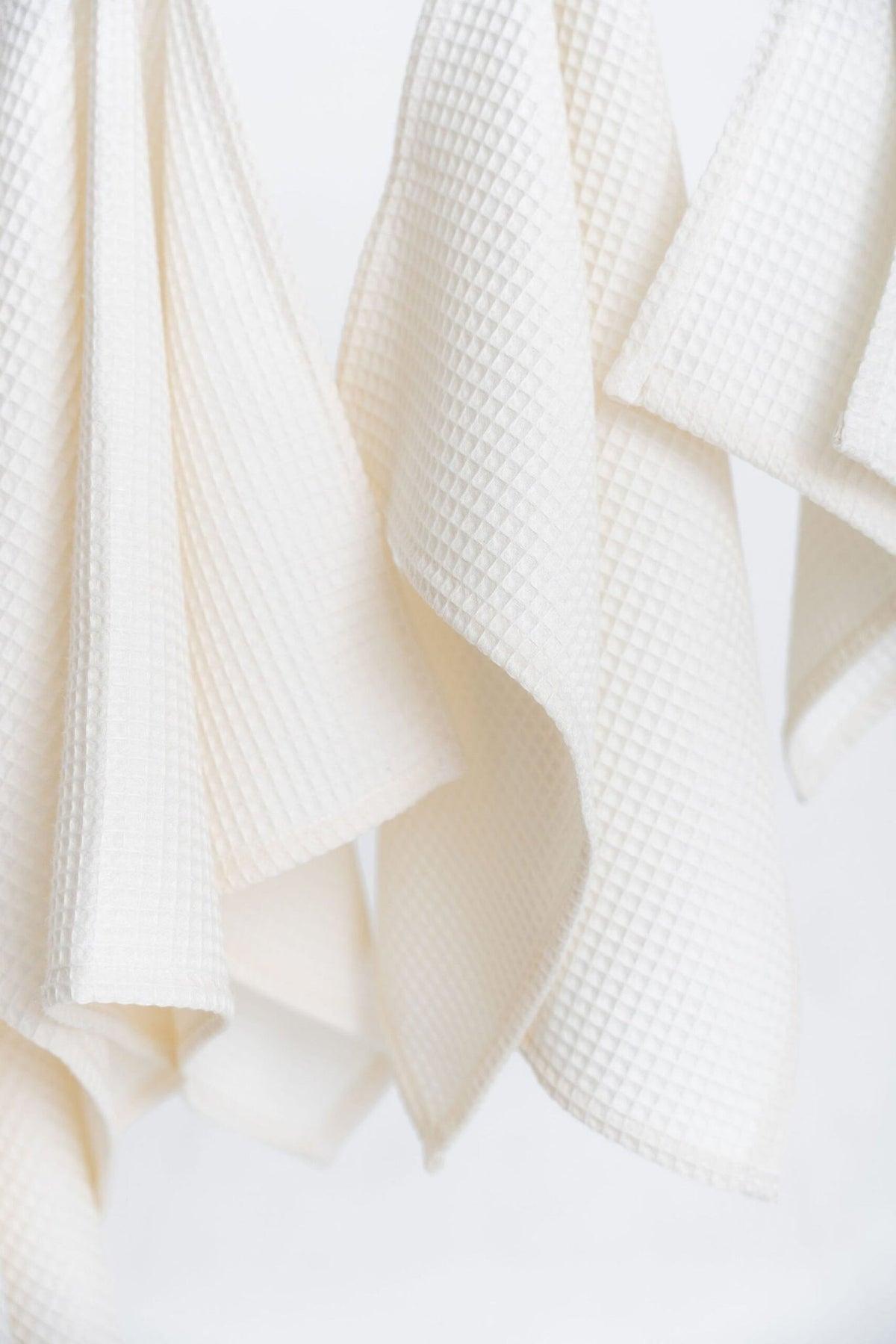 3. Close-up of cream waffle texture on organic cotton towels highlighting fabric detail