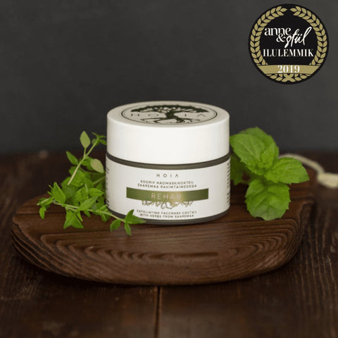 1. HOIA homespa Rehab Exfoliating Face Mask 50ML displayed on wooden tray with fresh herbs, award-winning skincare product