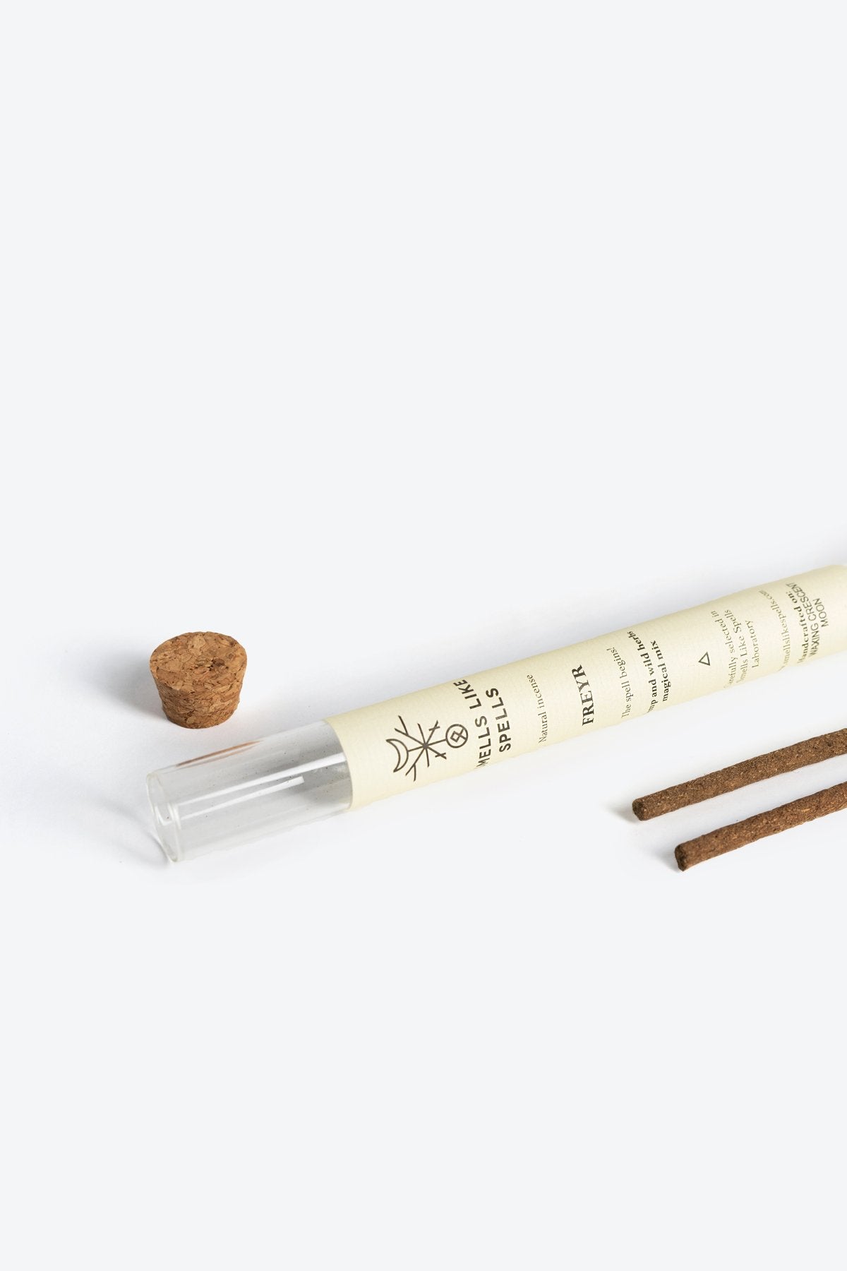 2. Smells Like Spells FREYR incense tube with cork stopper and two incense sticks on white background