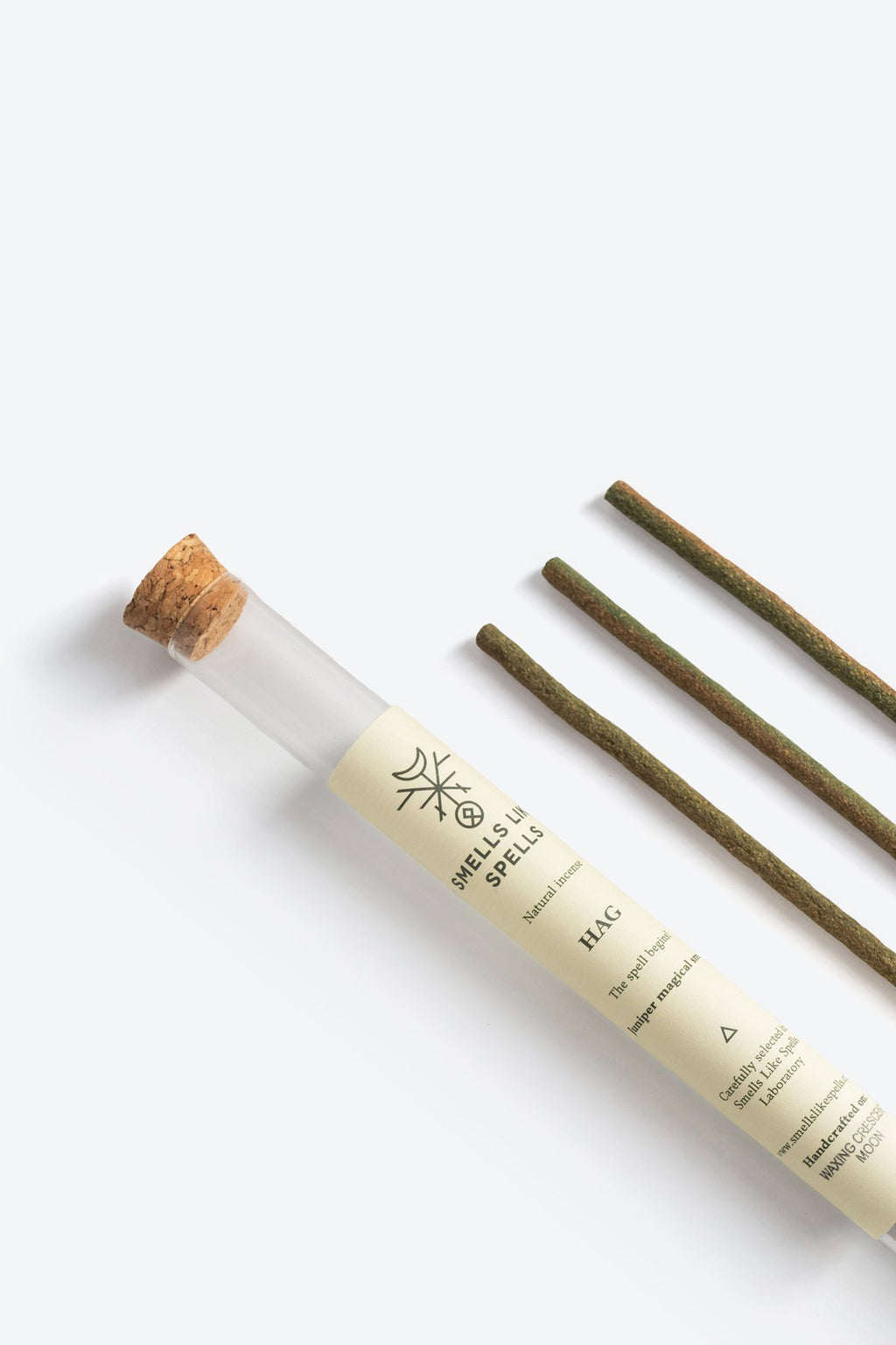 2. Close-up of Smells Like Spells Natural Incense HAG, featuring juniper sticks and branded glass tube