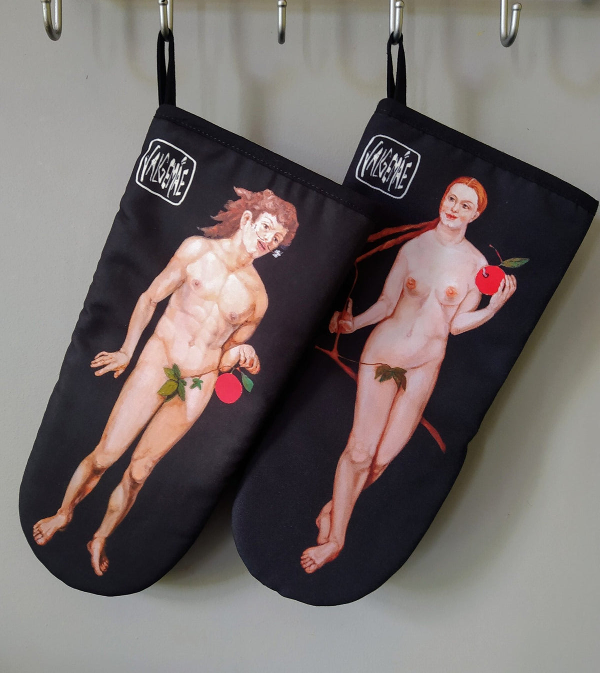 4. Pair of Katrin Valgemäe oven gloves with Adam and Eve prints hanging on hooks