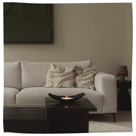 1. Cozy living room setting with Candledust powdered candle in a black container on a coffee table