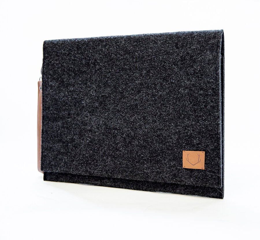4. Side view of Nordhale Berg black laptop bag in studio, highlighting recycled PET felt material