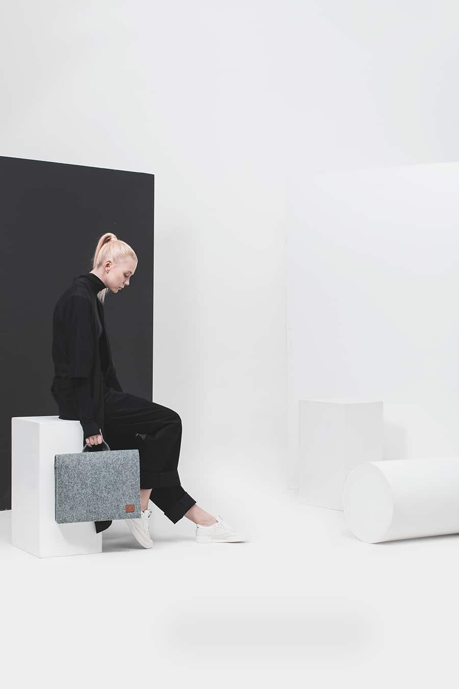 1. Unisex grey Nordhale Briefcase Hjo held by a model in a minimalist studio setting