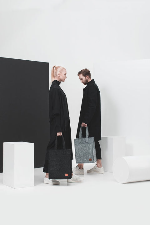 3. Unisex grey Hof Tote Bag by Nordhale, shown with models in a contemporary black and white studio
