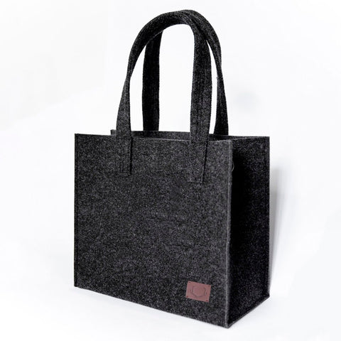 1. Unisex black Office Bag Holm by Nordhale in studio setting, showcasing minimalist design and recycled PET felt material