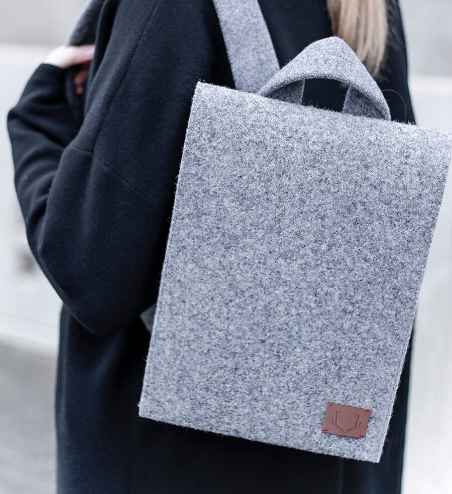 2. Close-up of woman wearing Nordhale Lund Mini Backpack in grey, showcasing felt texture