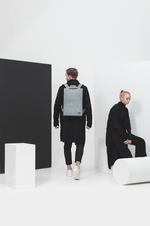 2. Unisex Nordhale Backpack Lund in grey worn by male and female models in a studio setting