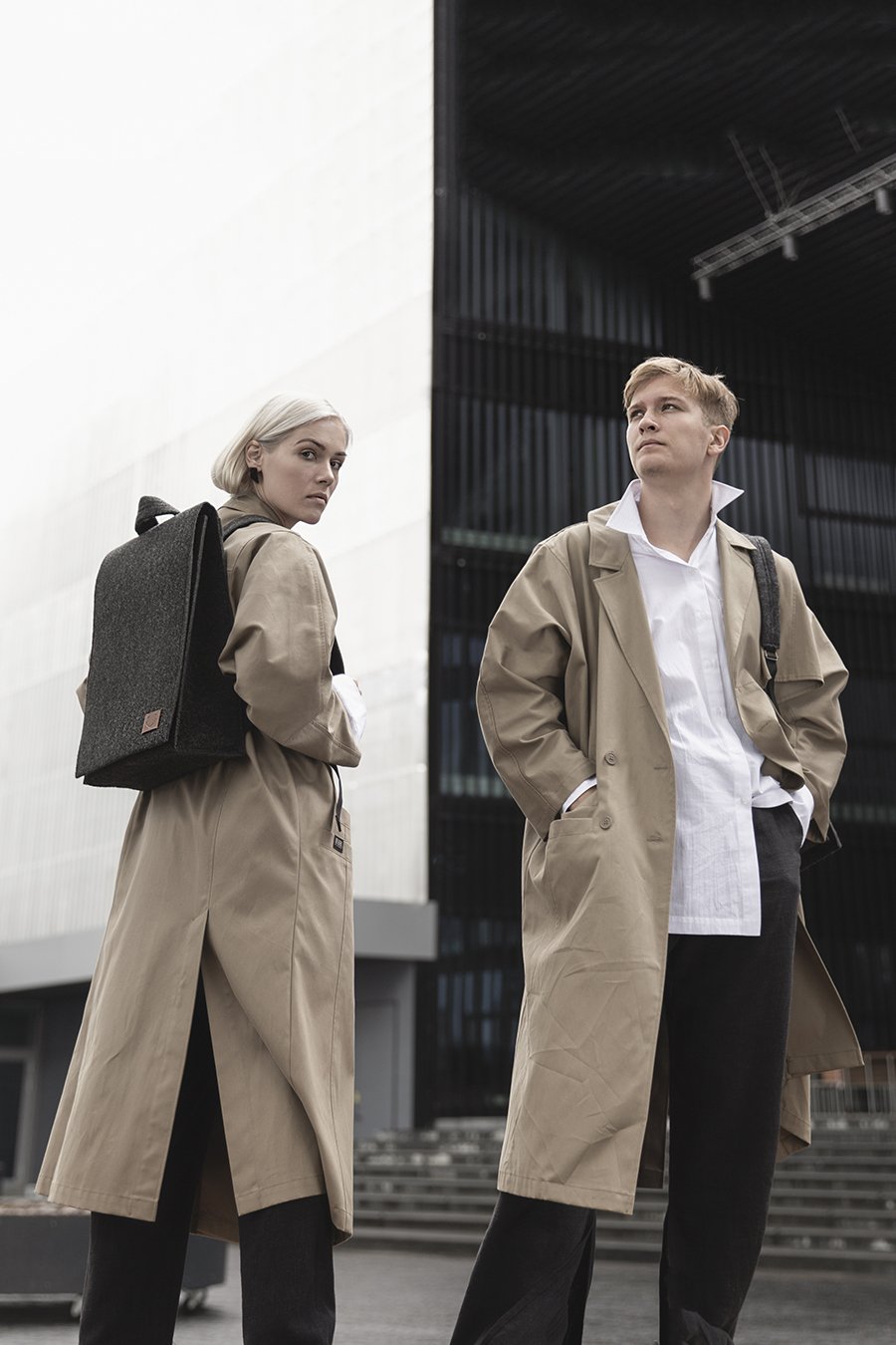 1. Unisex black Nordhale Backpack Lund worn by male and female models in urban setting