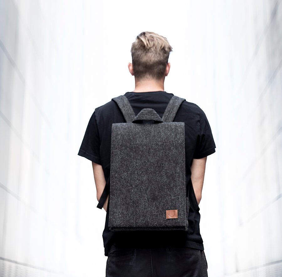 3. Unisex black Nordhale Backpack Lund shown from back on male model