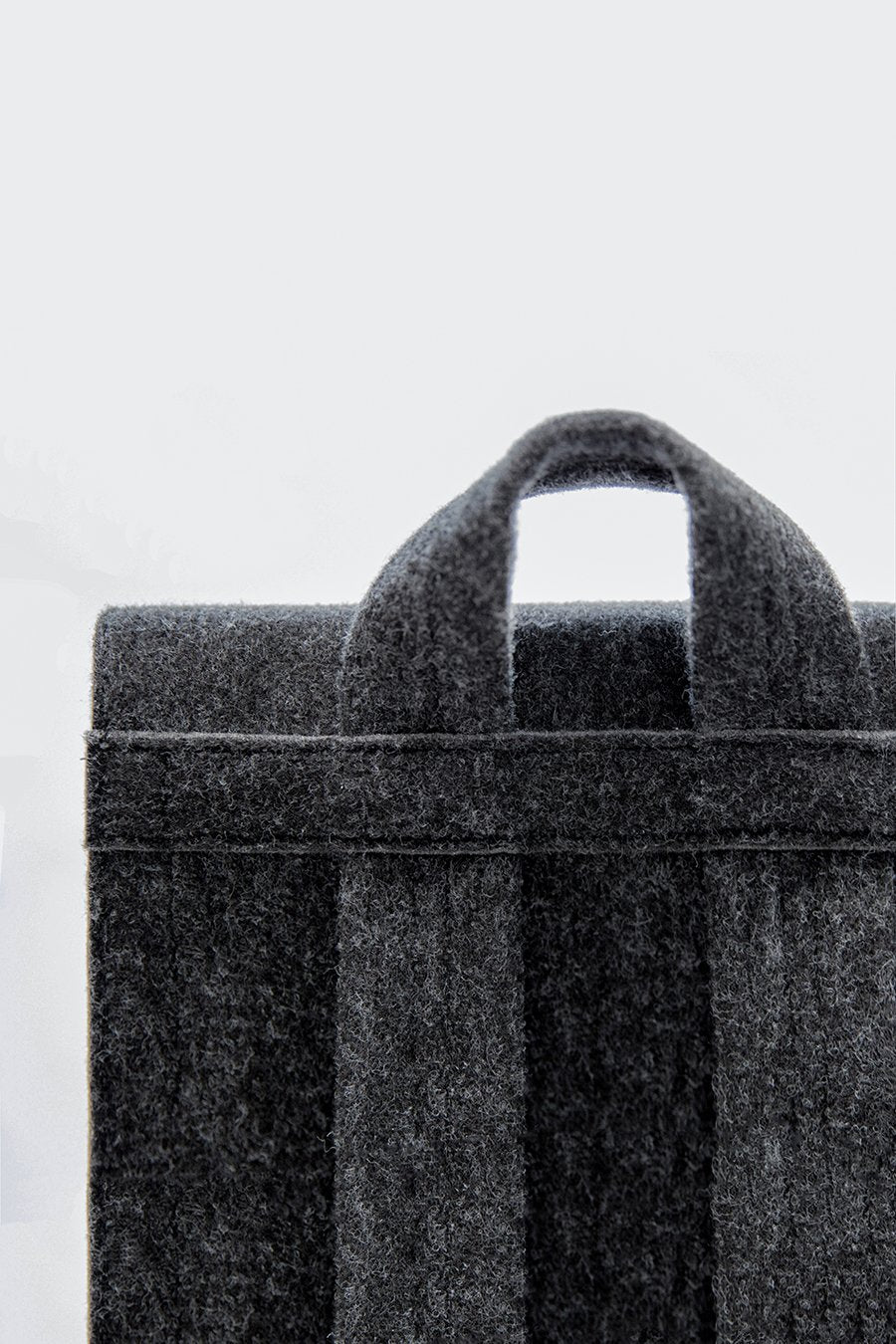 9. Close-up of handle and straps on black Nordhale Backpack Lund