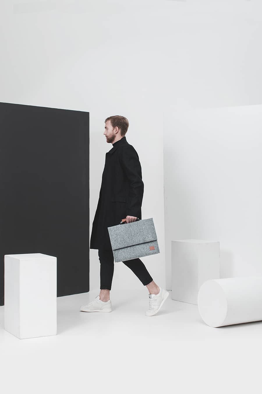 2. Woman holding Nordhale grey Briefcase Sören, highlighting sleek design and practicality