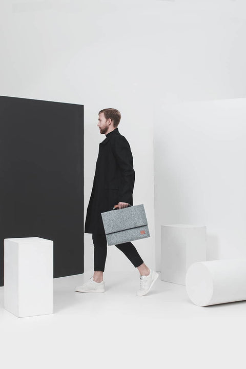 2. Woman holding Nordhale grey Briefcase Sören, highlighting sleek design and practicality