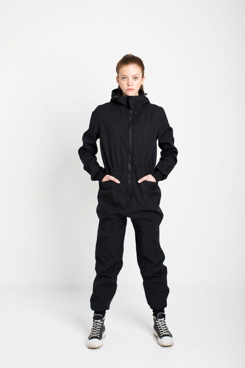 3. Women's KRISTINA softshell overall by Nuckö in black, studio shot with model hands in pockets
