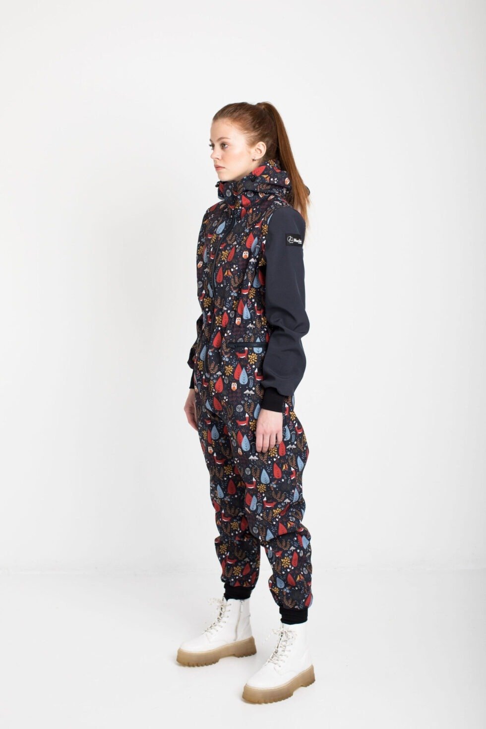 3. Women's EBEKAI softshell overall by Nuckö, shown in profile with breathable material and velcro strip